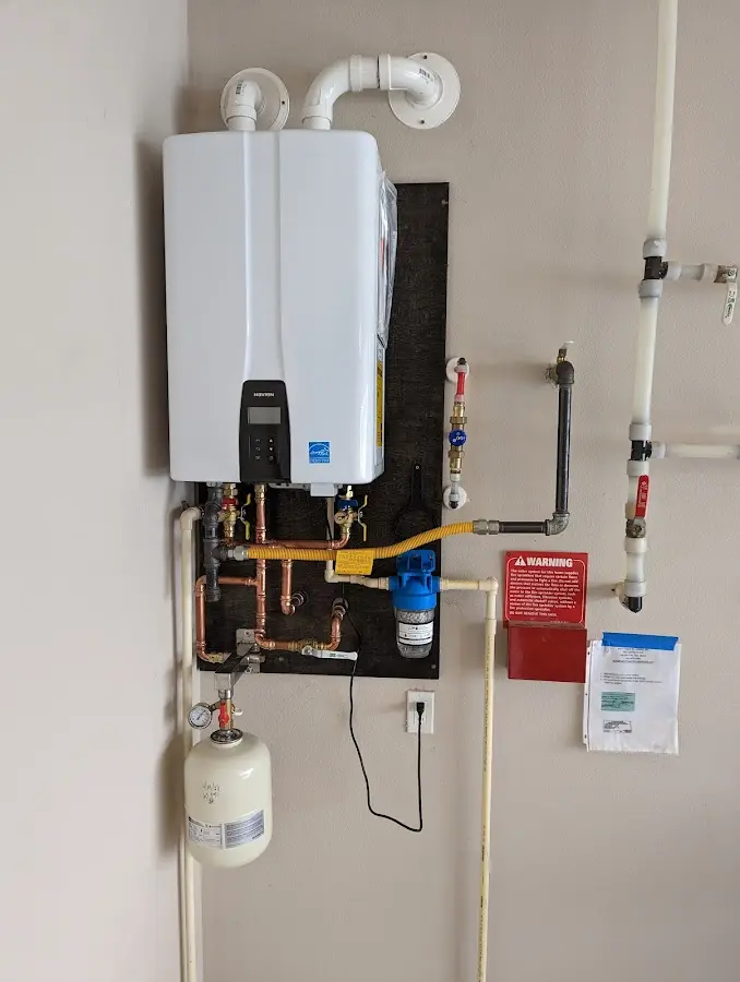 Professional plumber installing copper piping in a Lower Macungie home